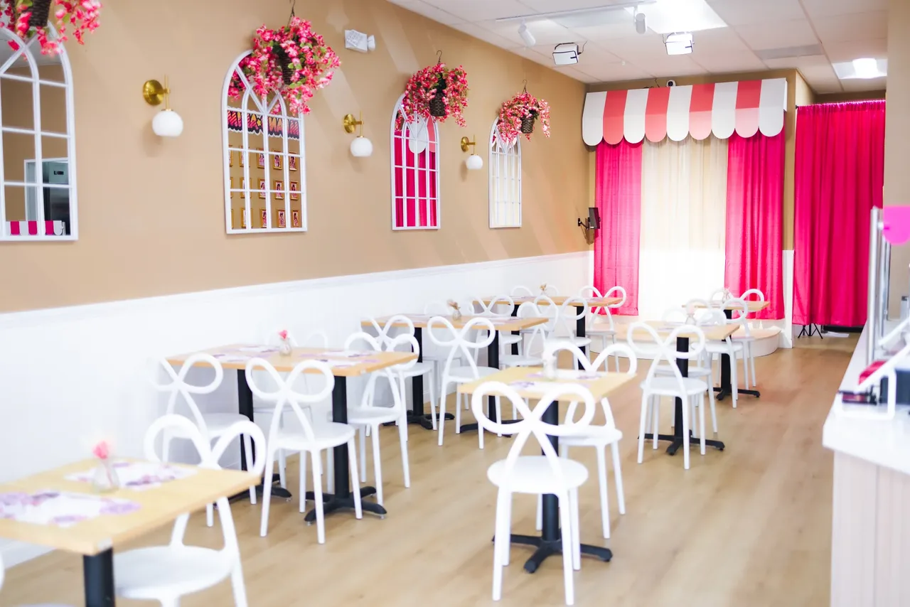 Dreamland’s pink cafe interior with tables, chairs and the stage