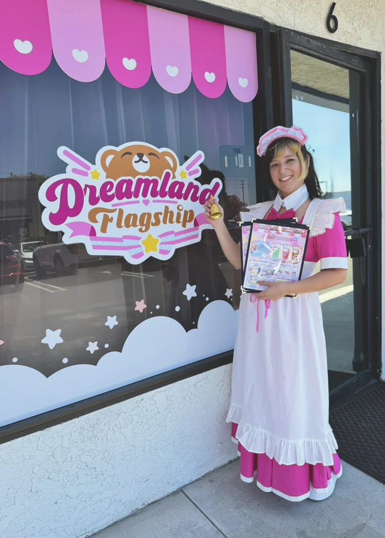Dreamland maid outside the café storefront